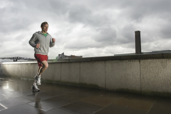 Young man jogging in cloudy weather to get in shape